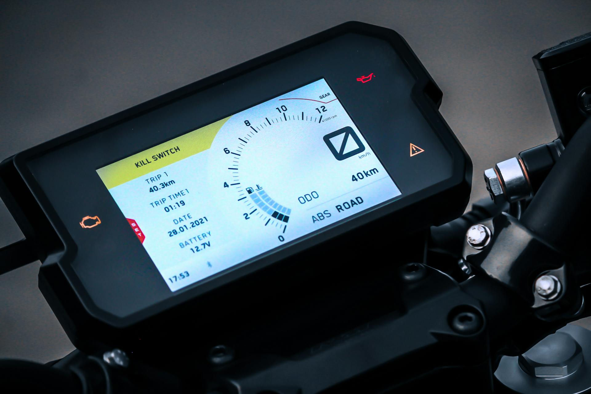 High-resolution image of a motorcycle dashboard with digital display and controls.