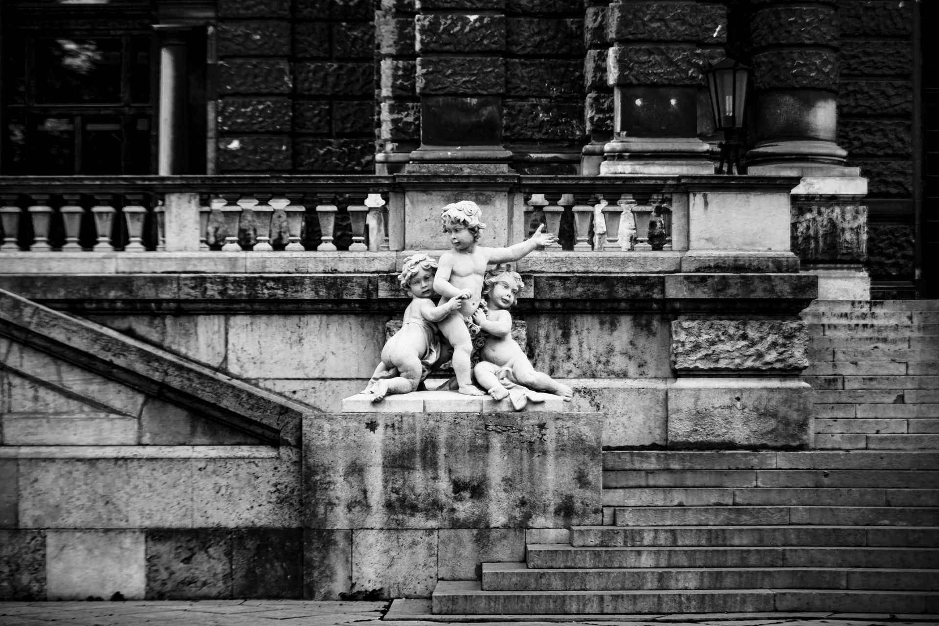 Black and white photo of cherubic statues and historic architecture in Vienna.