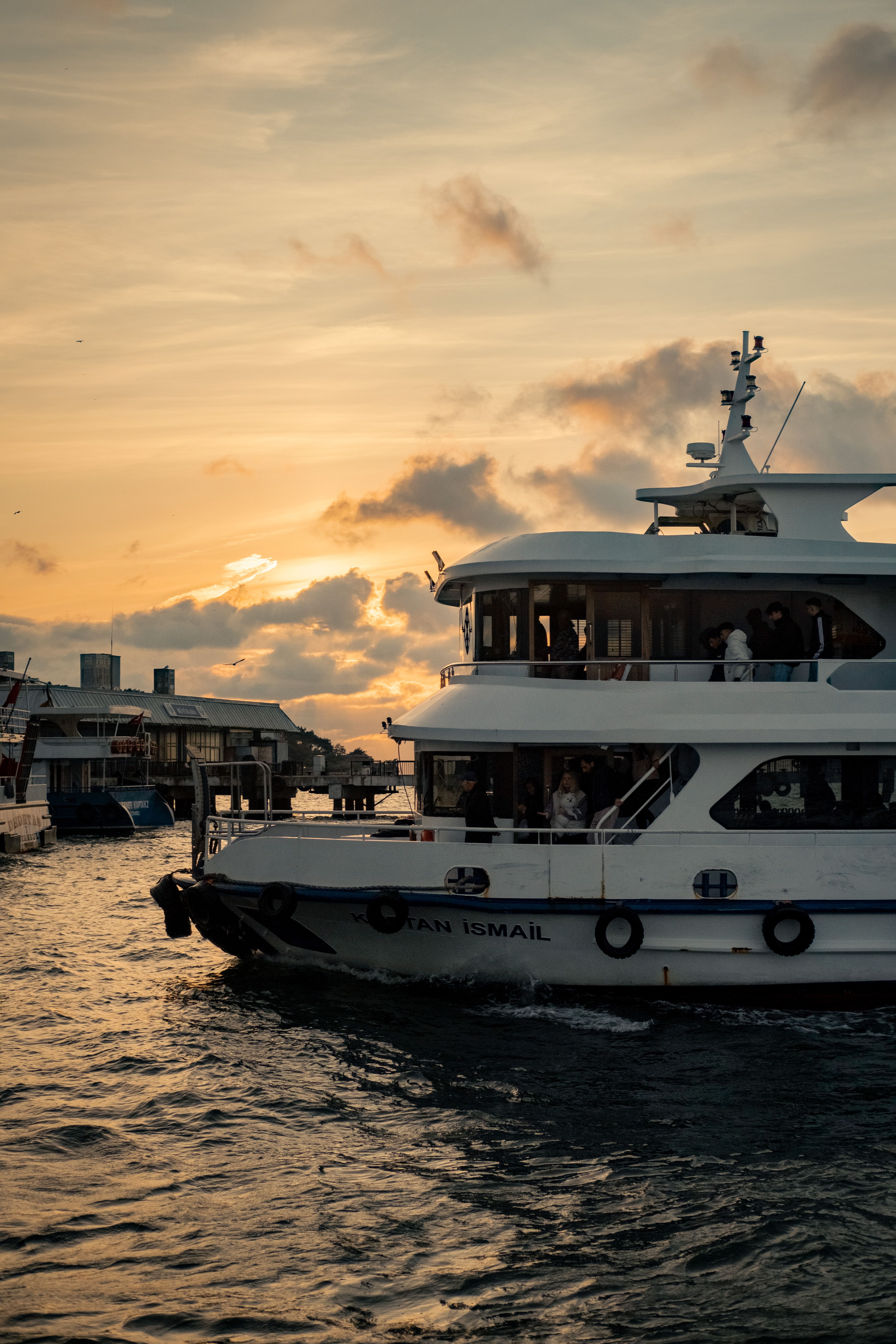 Luxury dinner cruise catamaran departing Benoa Harbour at sunset in Bali