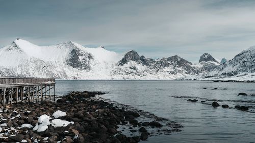 Free Breathtaking view of snow-covered mountains and calm waters in Arctic Northern Norway. Stock Photo