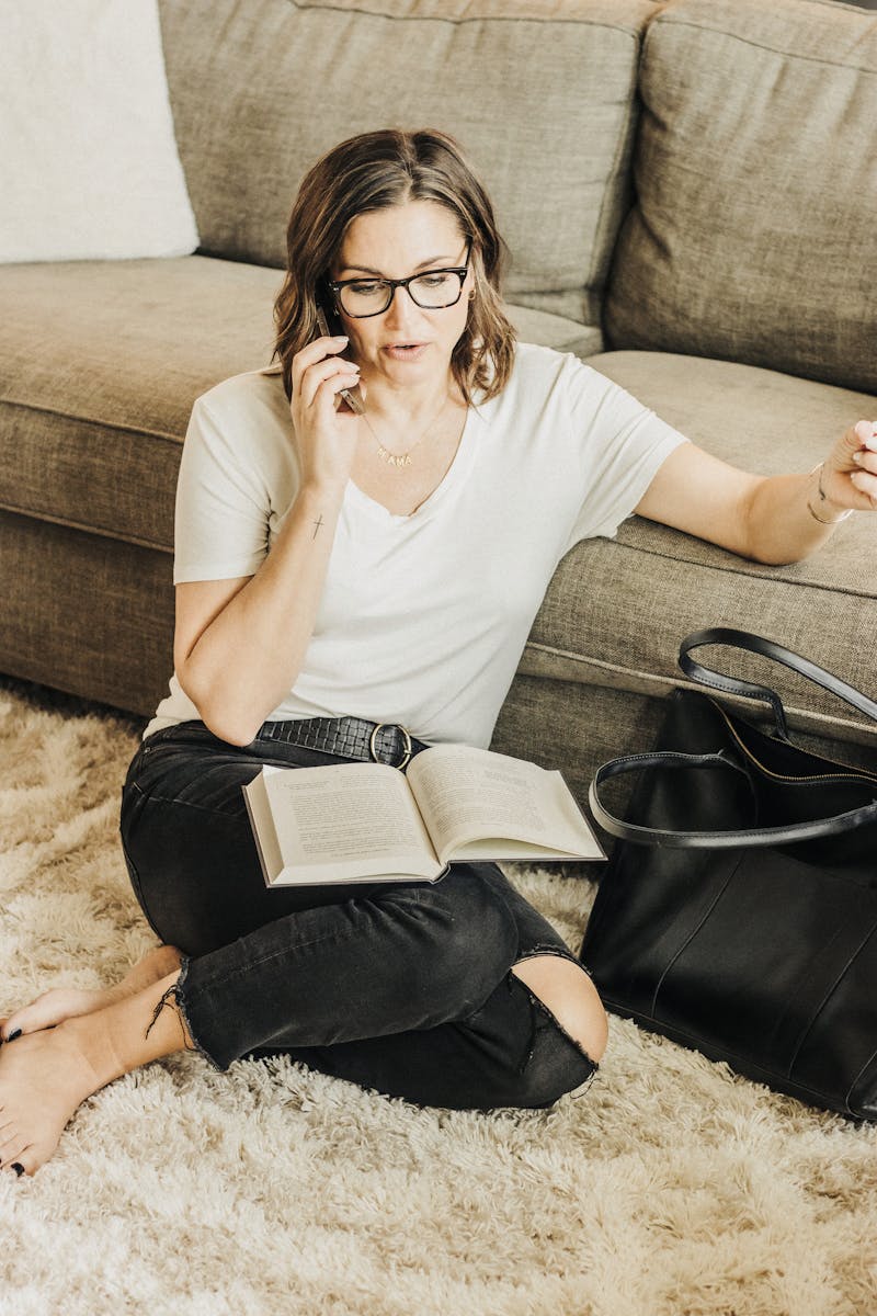 Woman talking on phone with journal in lap, representing supportive admissions process