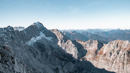 Free Stunning view of the snowy peaks of the Bavarian Alps under a clear blue sky, capturing the serene beauty of winter. Stock Photo