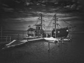 Monochrome Photo of a Pirate Ship Docked at a Harbor