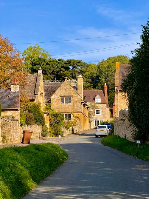 Free Picturesque street in a charming English village with traditional stone houses in autumn. Stock Photo