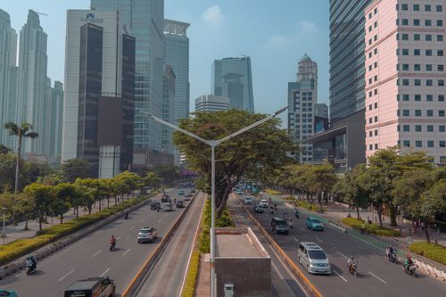 Free High-rise buildings and traffic on a busy Jakarta street during the day. Stock Photo