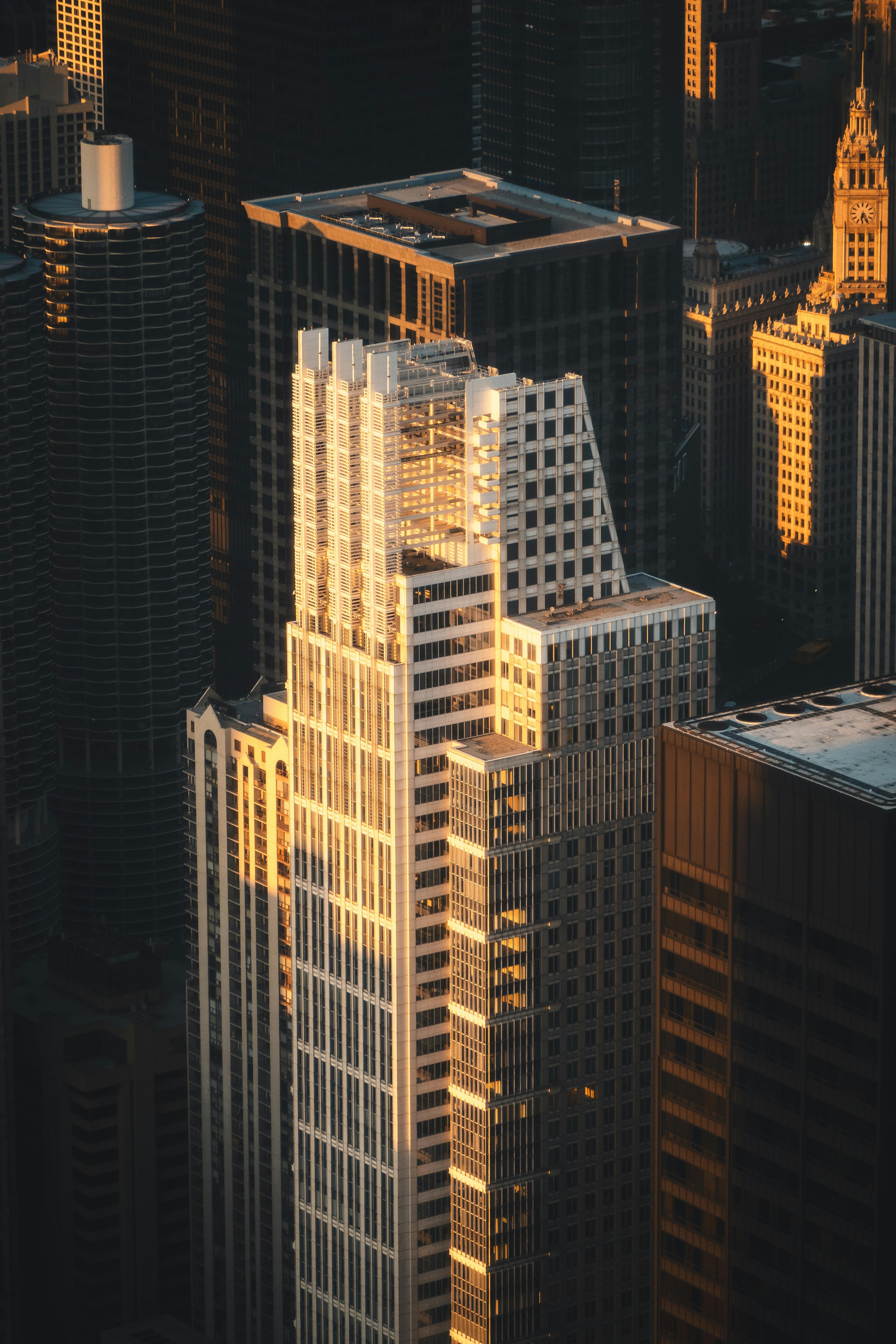Aerial view of downtown skyscrapers illuminated by warm sunset light showcasing urban architecture.