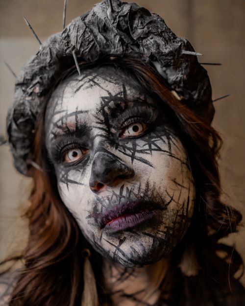 Free Close-up portrait of a person with surreal horror makeup and gothic elements, perfect for Halloween themes. Stock Photo