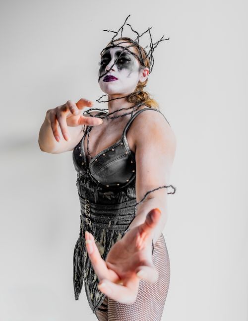 Free Artistic portrait featuring surreal makeup and costume with a dark, gothic theme. Stock Photo