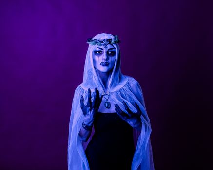 A mesmerizing portrait of an adult in surreal gothic costume with expressive makeup, captured in a mysterious purple hue.