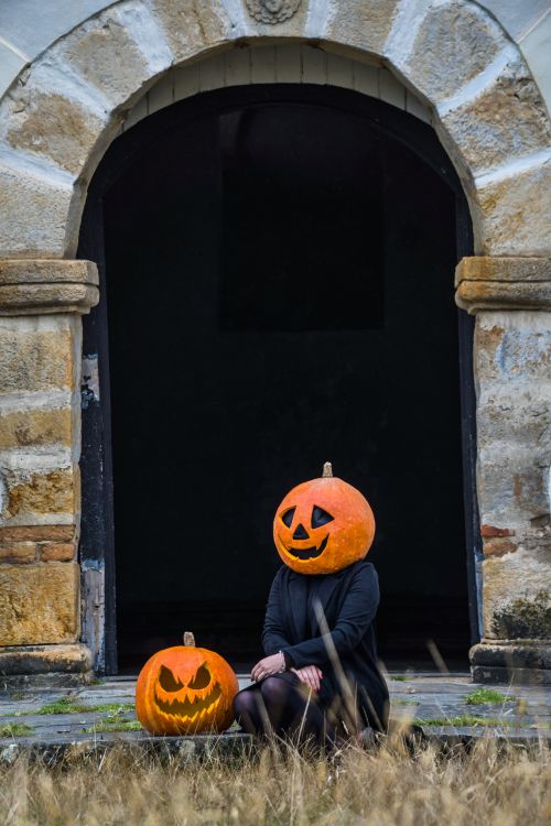 Free Person with pumpkin head costume sitting in Guasca, Colombia at night. Stock Photo