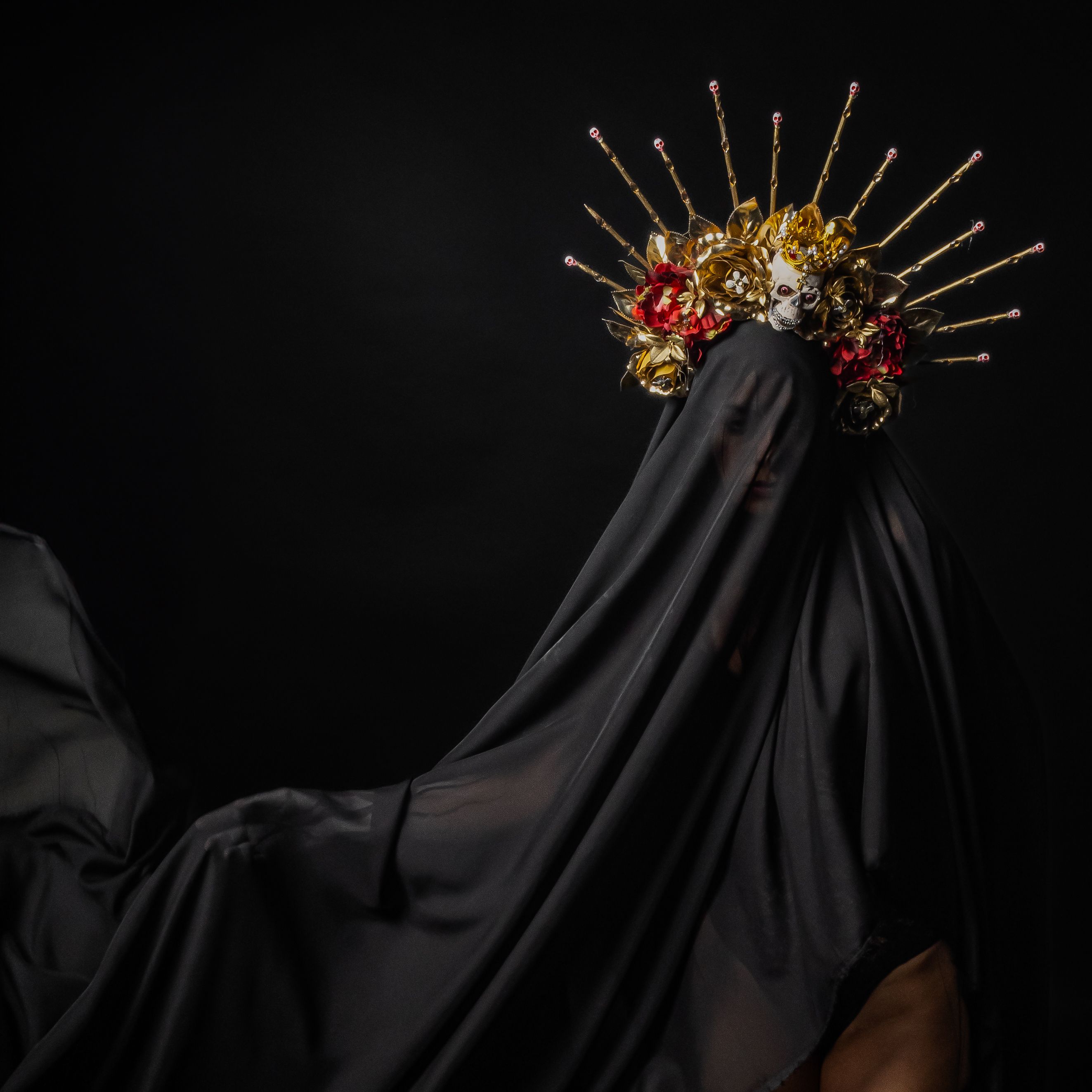 Dramatic gothic portrait with elaborate headpiece, featuring surreal elements and dark tones.