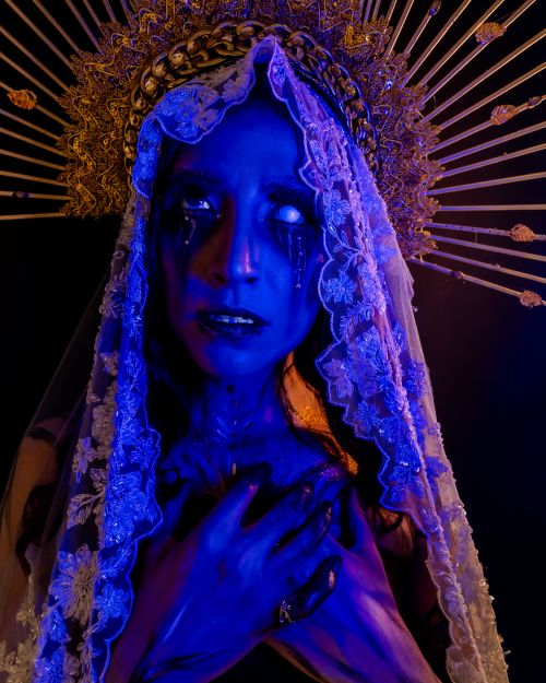 Free Fantasy-inspired gothic portrait with surreal makeup in dramatic lighting. Stock Photo