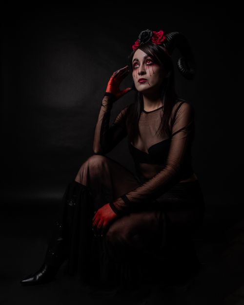 Free Artistic portrait of a woman in surreal, gothic costume with horns, in low light setting. Stock Photo