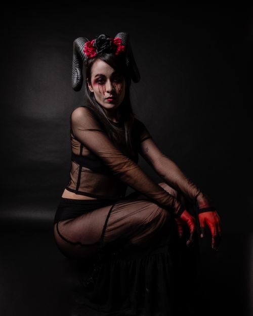 Free A surreal portrait featuring dark makeup and a gothic costume in a moody setting. Stock Photo