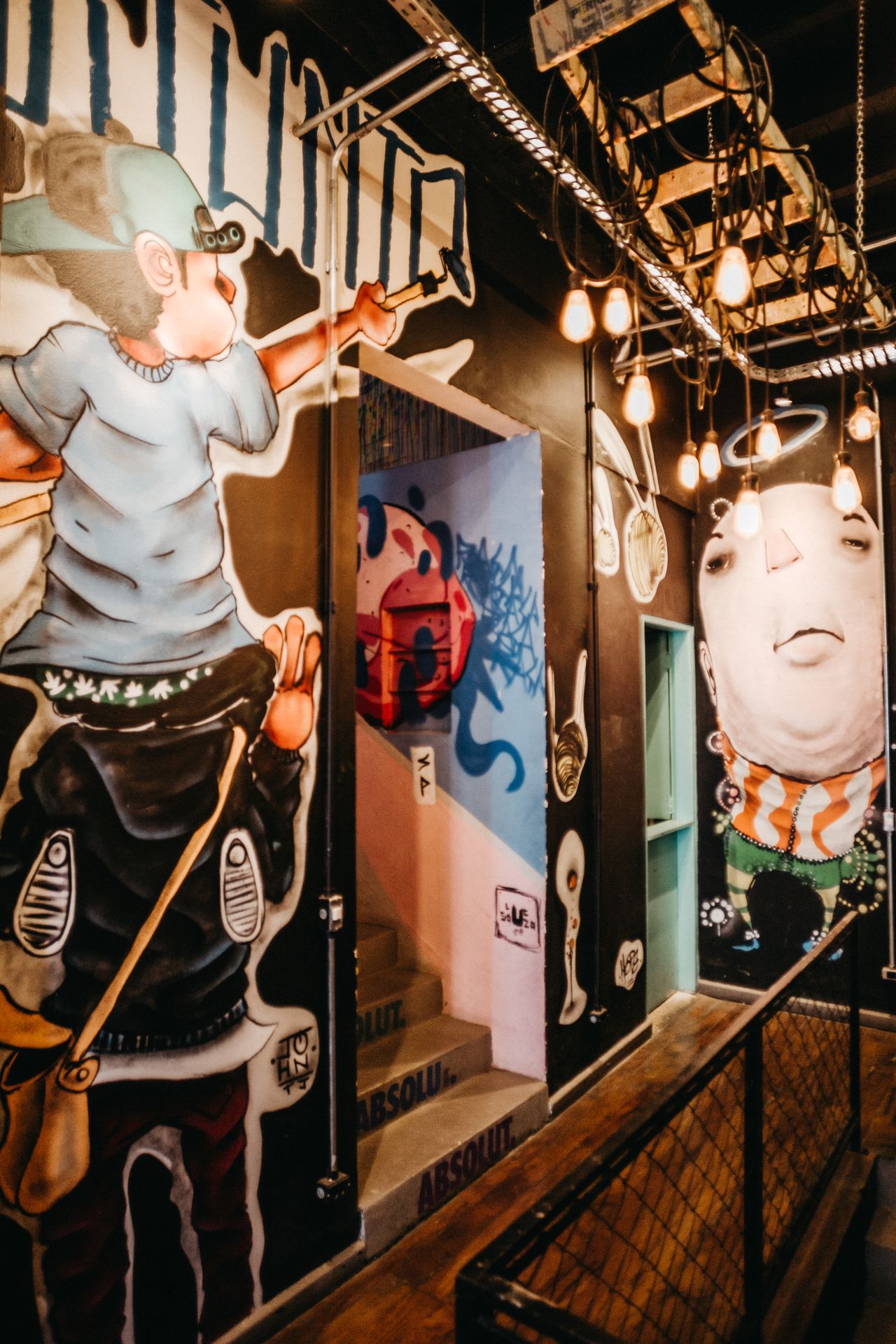 wall-art-mural-garage Colorful graffiti murals covering the walls of an industrial space