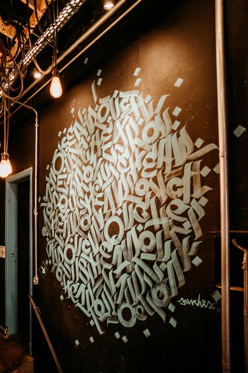 Free Close-up of graffiti art in urban setting, displaying bold text and industrial design. Stock Photo