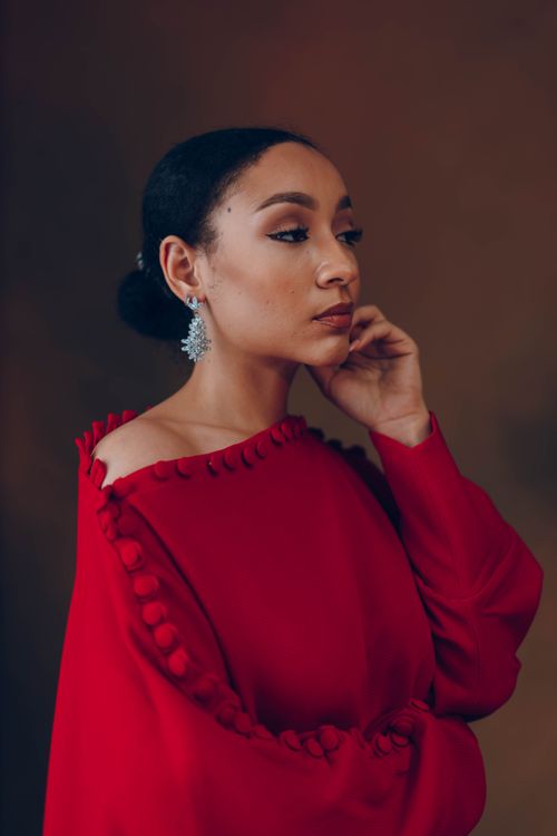 Free Portrait of a woman in an elegant red dress, showcasing African fashion and beauty. Stock Photo