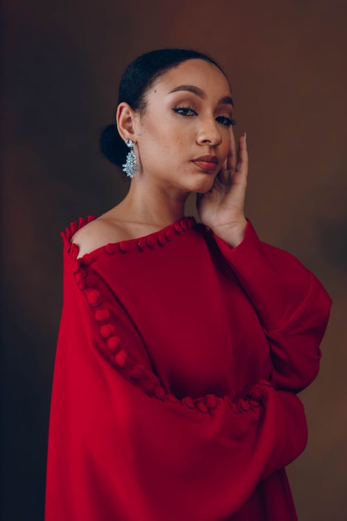 Free Stylish portrait of a woman in a red traditional African dress, shot indoors. Stock Photo