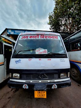 Front view of a vibrant local bus in Rishikesh, adorned with Hindi text and decoration.