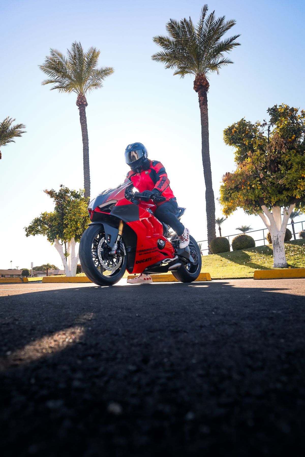 Photo of a Person with a Red Helmet Riding a Motorcycle · Free Stock Photo