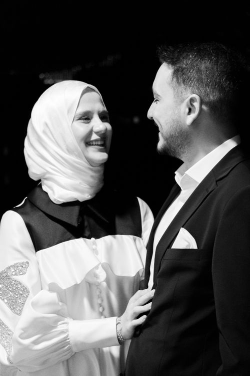 Free A black and white portrait of an elegant couple smiling at each other. Stock Photo