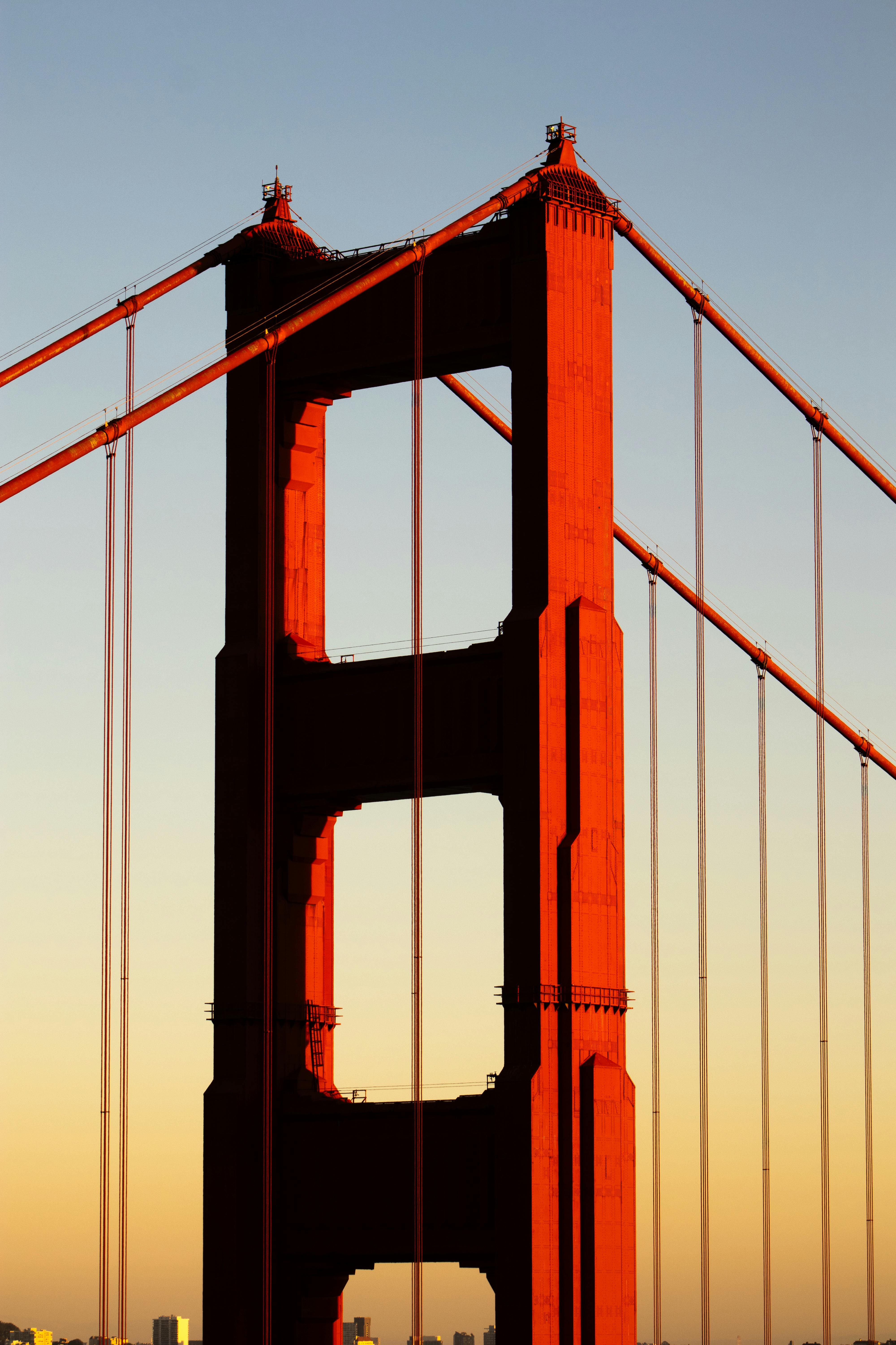 Close-up of Golden Gate Bridge at sunset highlighting its iconic red towers in San Francisco.