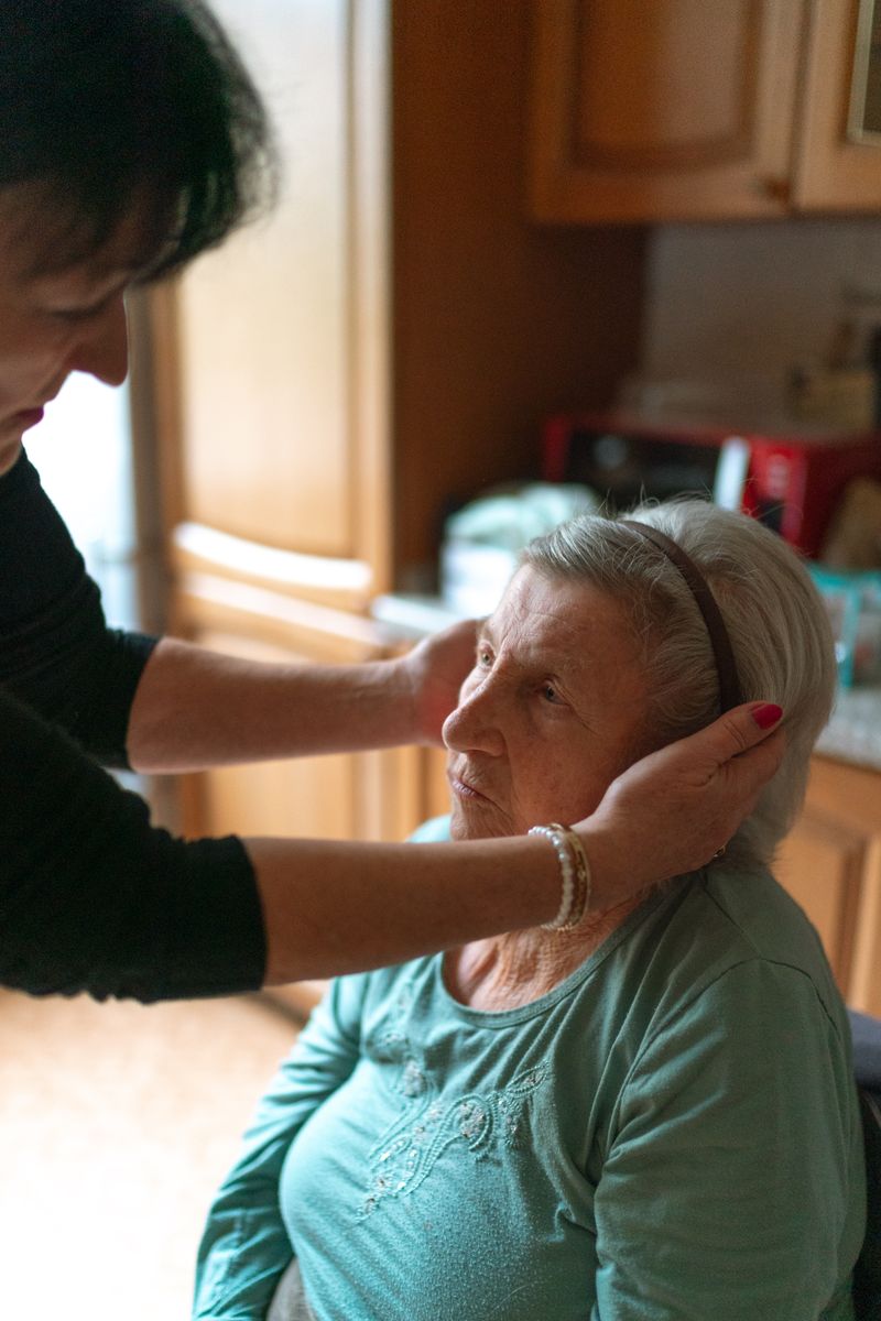 Caregiver assisting a senior woman at home