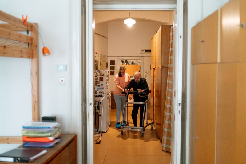 Caregiver supporting an older person at home