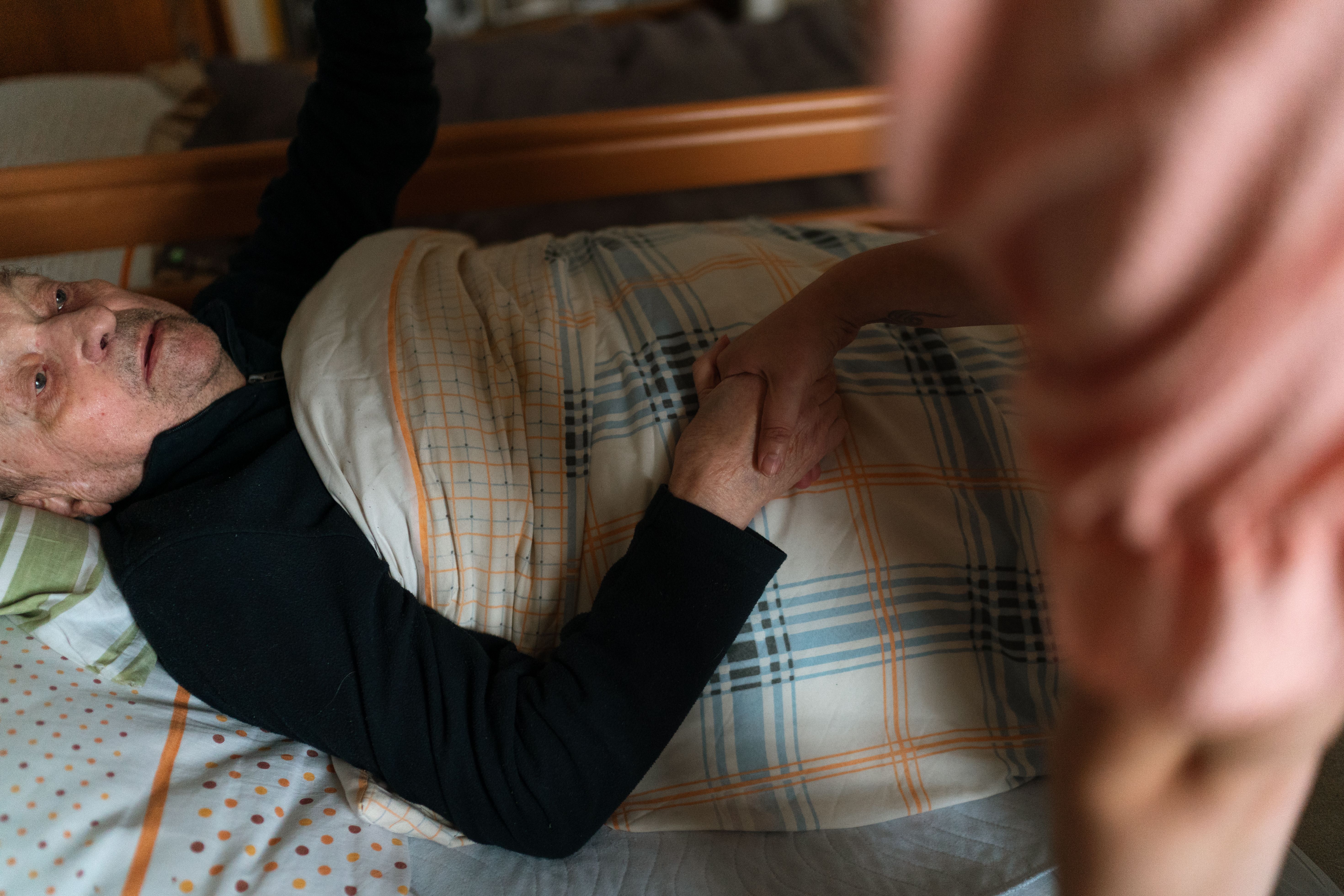 Caregiver holding hands with senior