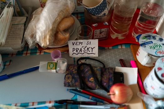 An organized Prague kitchen counter featuring food items, reminders, and daily essentials.