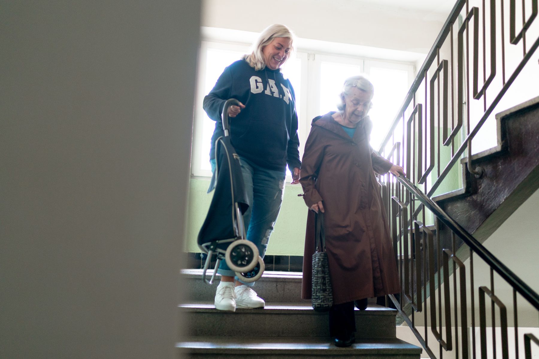 Assisted Living Lead Generation Agency Hero Assisted Living Lead Generation Agency: caregiver helping an older resident move safely through a senior living community