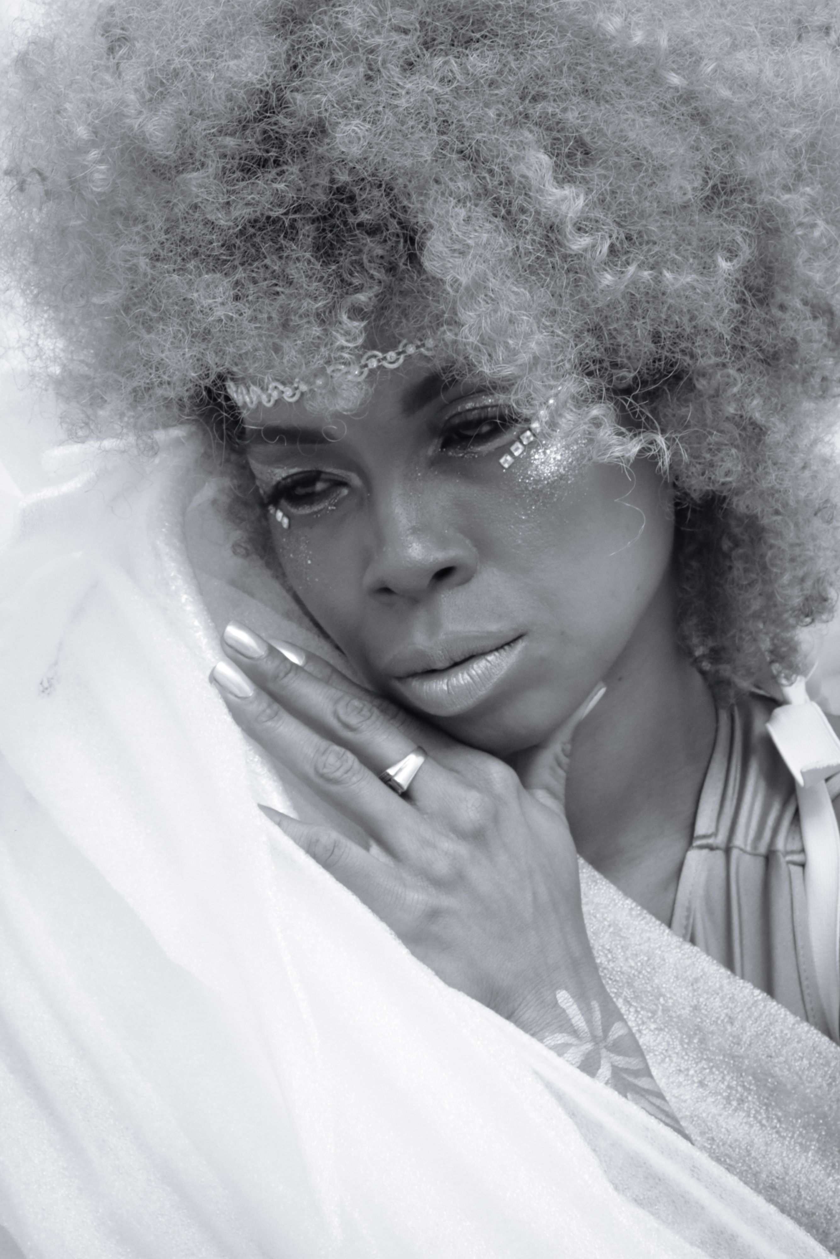 Elegant Portrait of a Thoughtful Woman with Curly Hair · Free Stock Photo