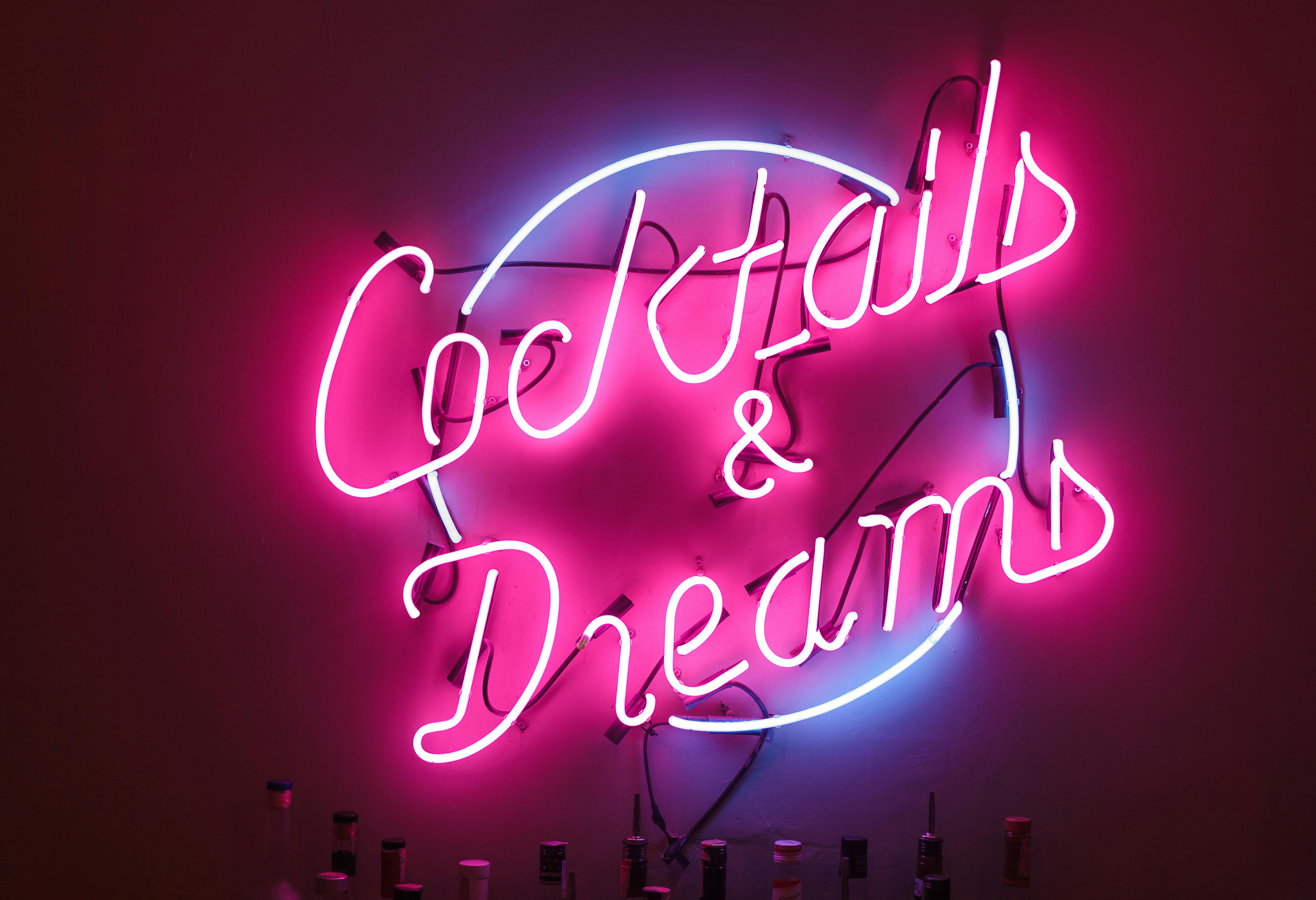 Vibrant Neon Sign Reading Cocktails & Dreams · Free Stock Photo