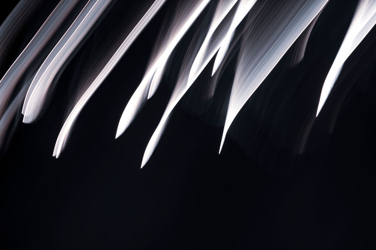 abstract motion capture of light streaks with dynamic flow on a dark b