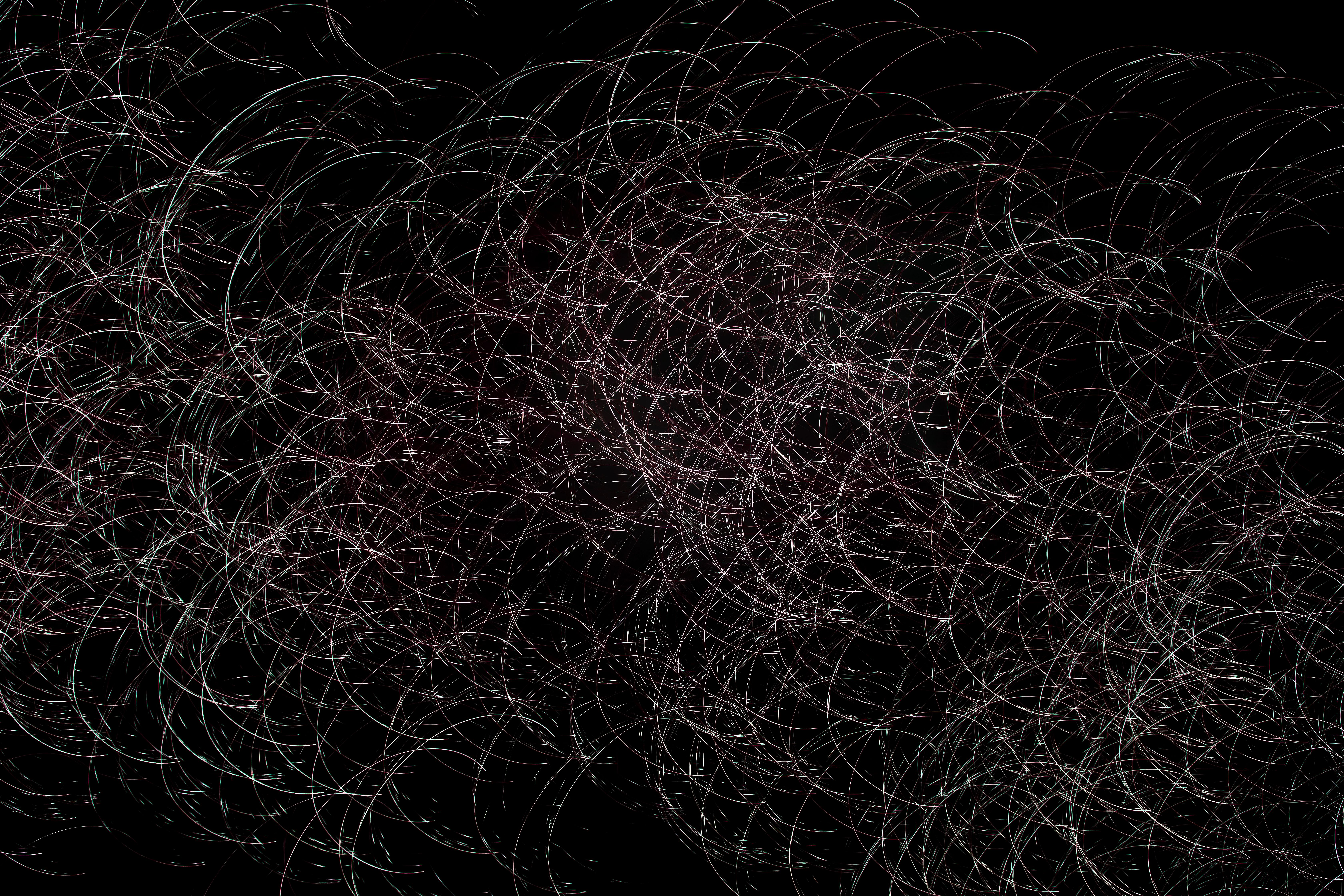 Dynamic abstract image of circular light trails creating an intricate pattern on a black background.