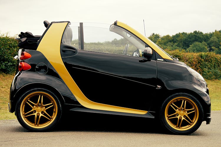 Black And Yellow Smart Car On Focus Photography