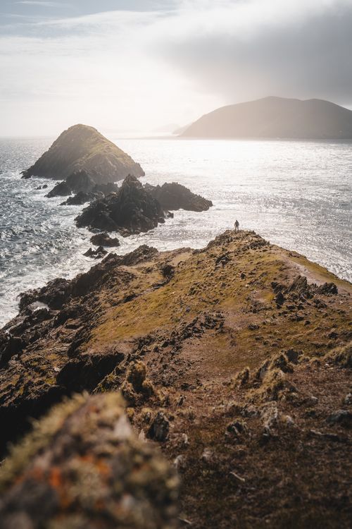 Free A breathtaking view of rugged coastal cliffs under the soft light of a cloudy day, ideal for nature lovers. Stock Photo