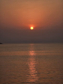 Beautiful sunset casting reflections over a serene ocean view.