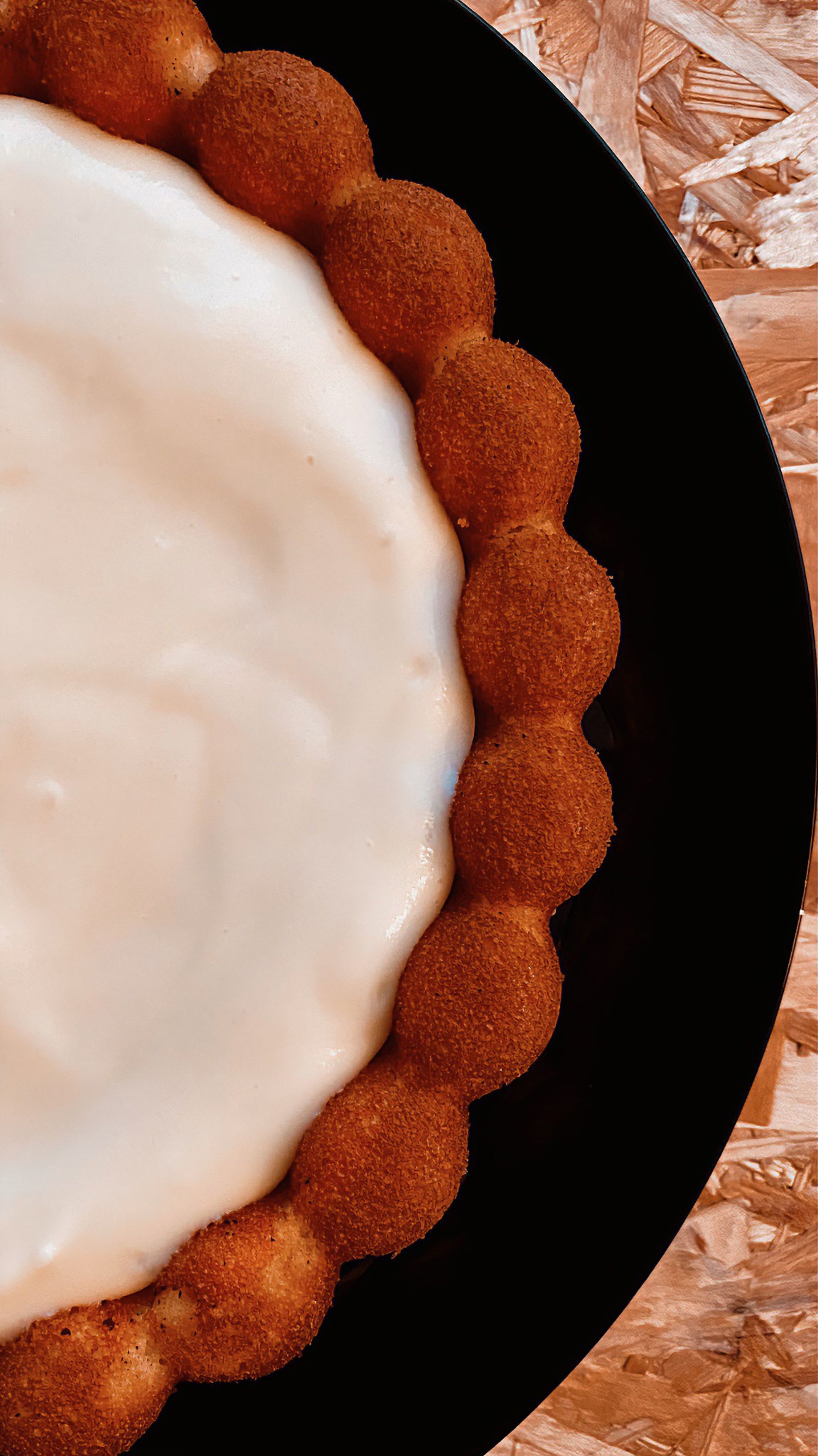 Delicious creamy dessert on a black plate, perfect for food photography.