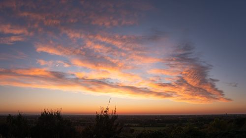 Free A stunning sunset over Hamburg with vivid orange clouds and a tranquil horizon. Stock Photo