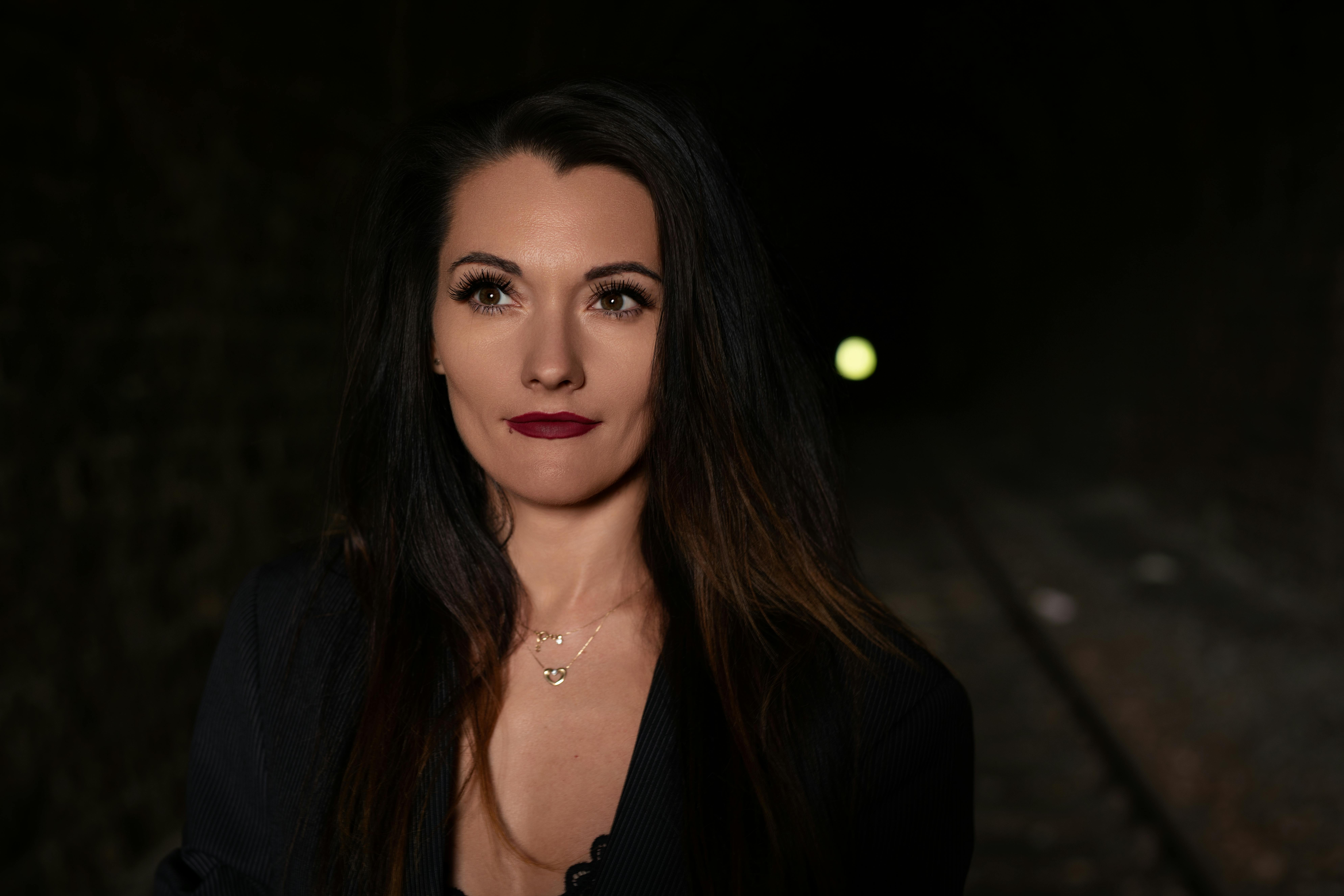 Elegant woman in a dark tunnel with subtle lighting. Perfect for mood and mystery themes.