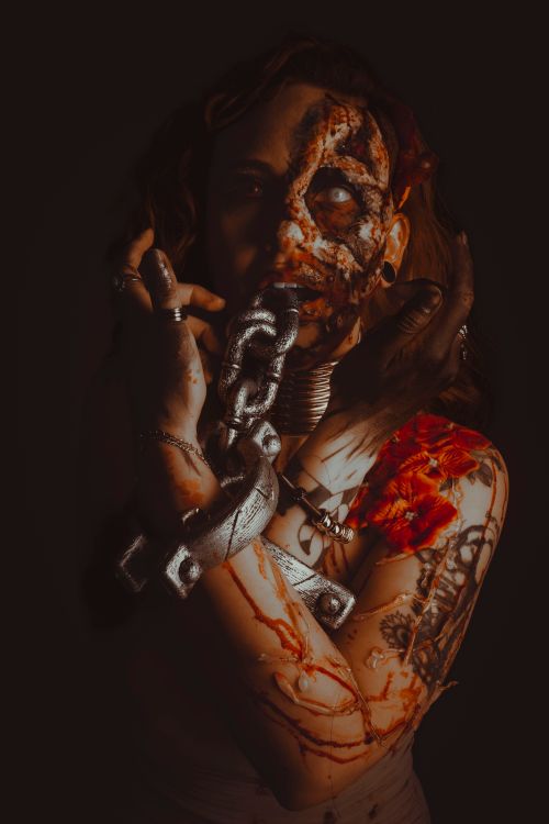 Free Dark, artistic portrait of a woman with chains and tattoos, creating a hauntingly surreal atmosphere. Stock Photo