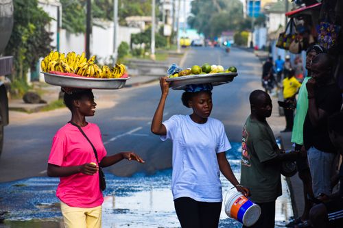 Free Two women selling bananas and limes on the streets of Monrovia, Liberia. Stock Photo