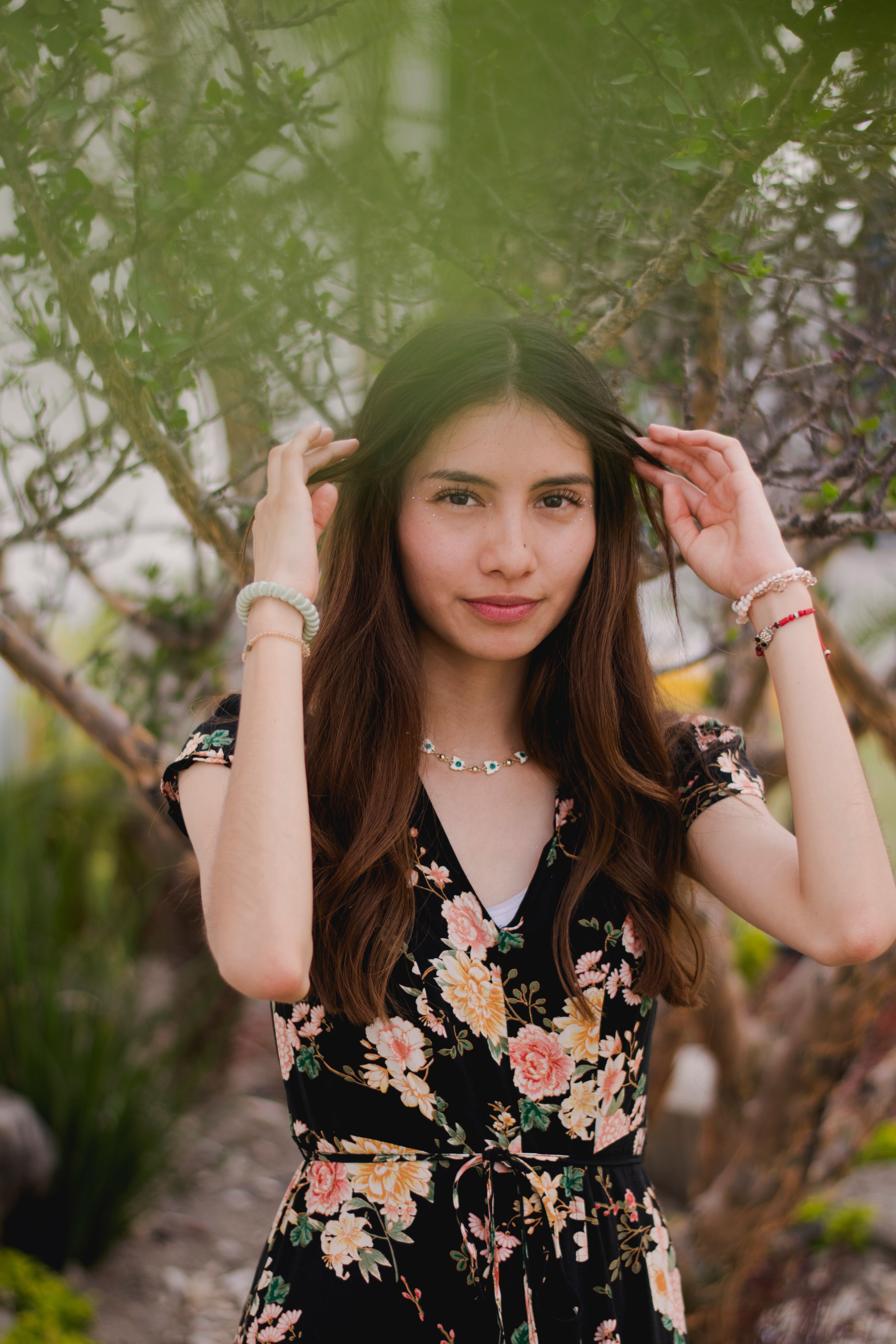 Young Woman in Floral Dress Outdoors · Free Stock Photo