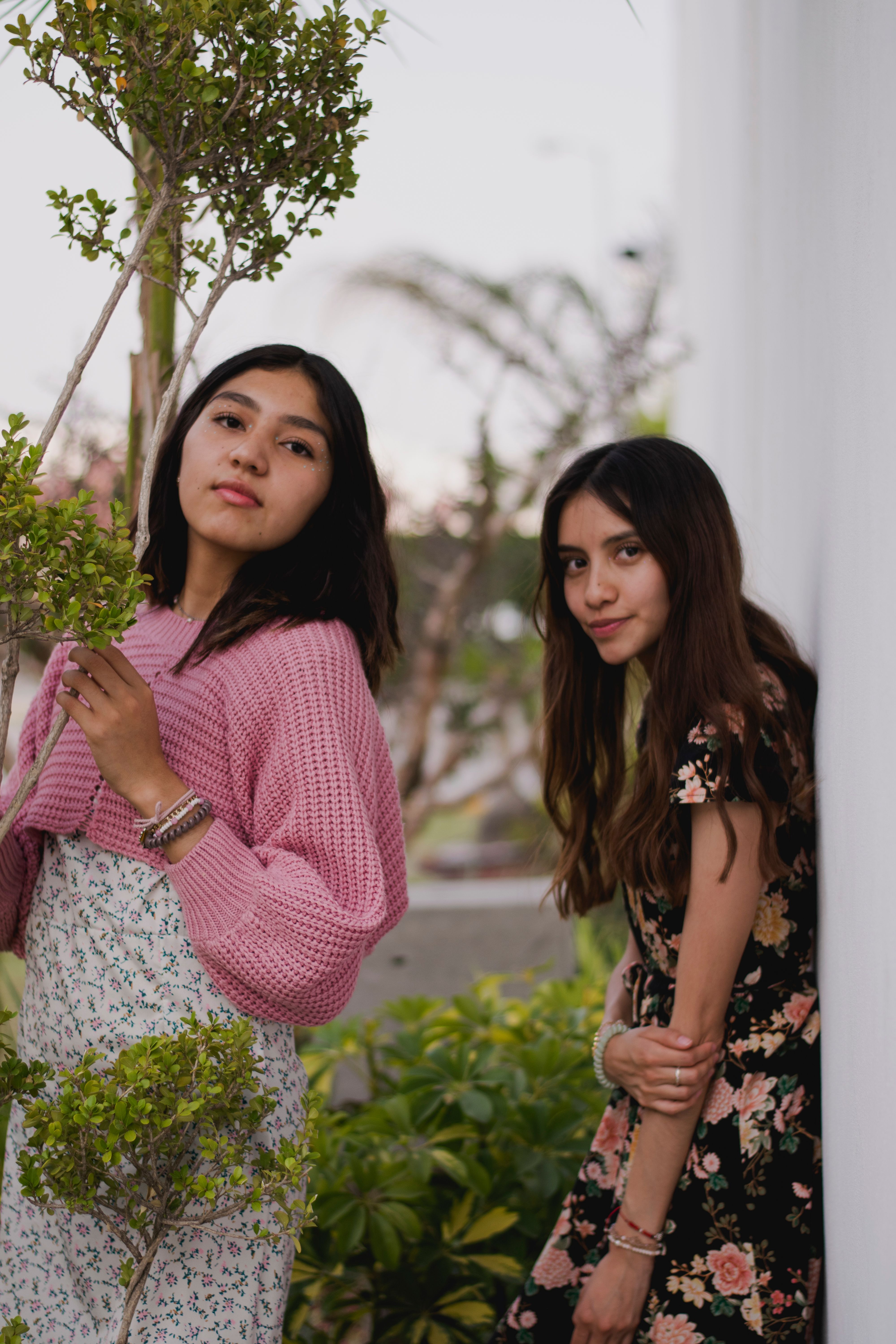 Two Young Women in Floral Dresses Outdoors · Free Stock Photo