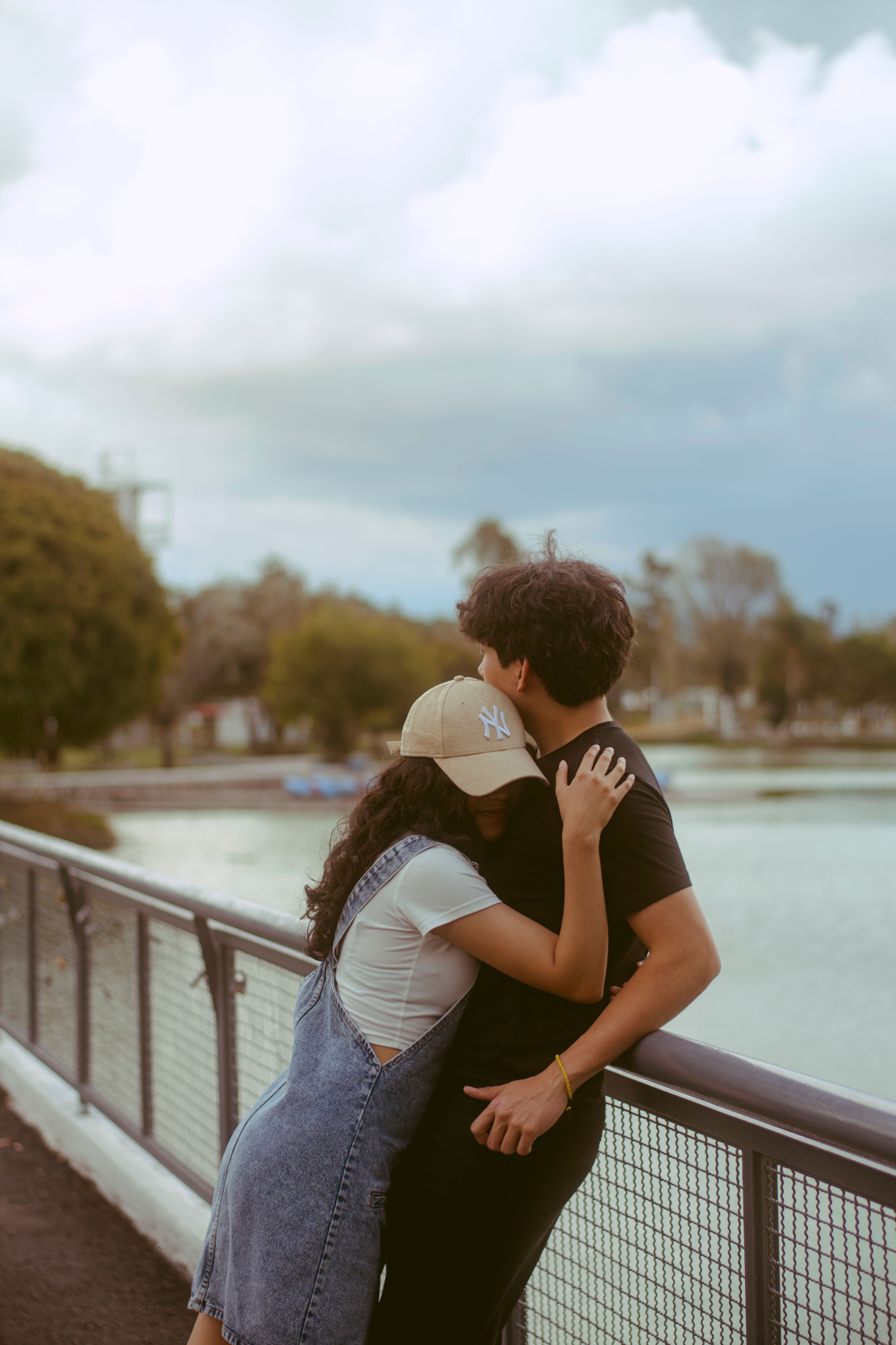 Young Couple Hugging by Scenic Lakeside · Free Stock Photo