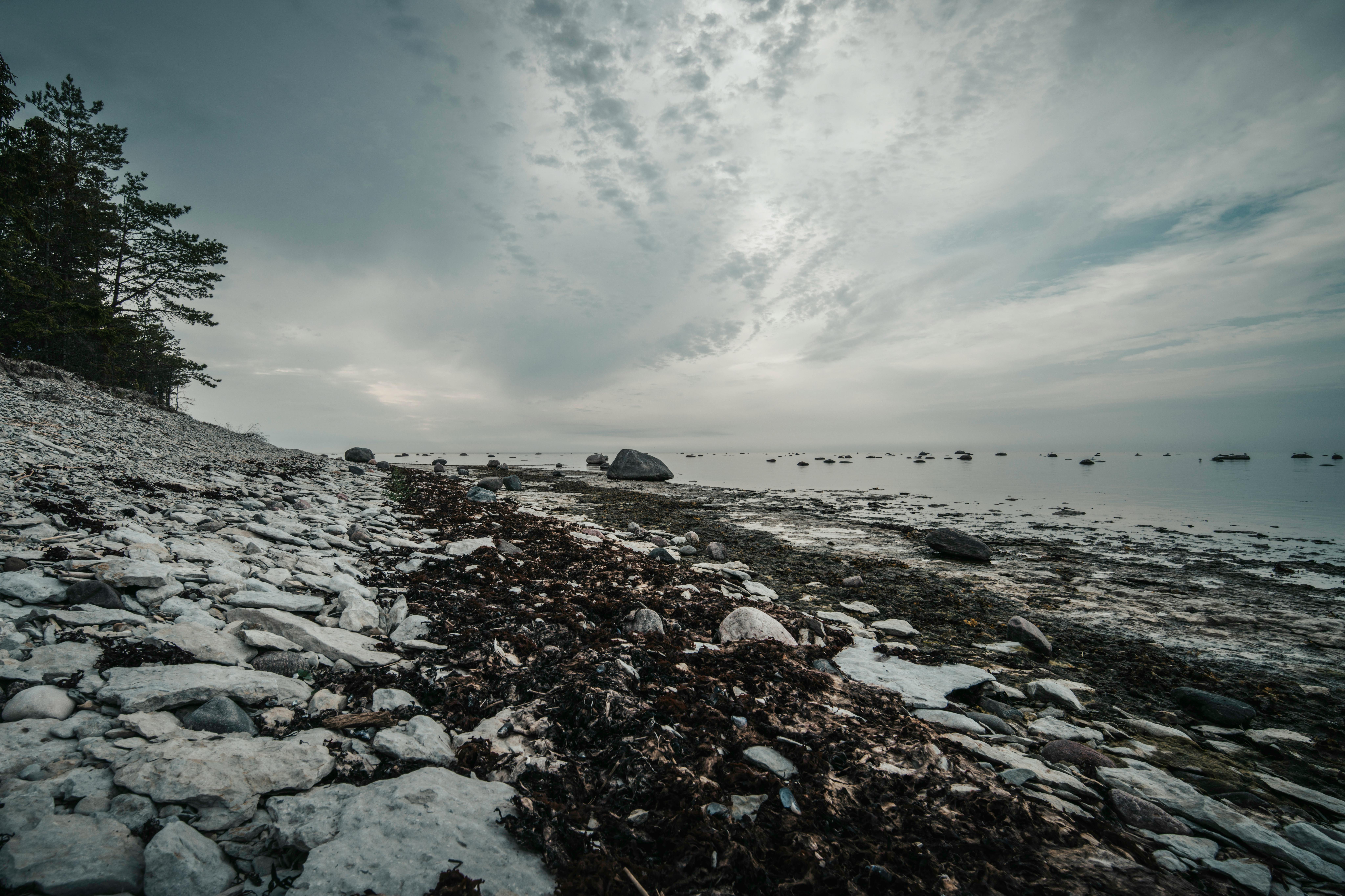 Captivating rocky shore with dramatic clouds at Põõsaspea Neem, untouched nature in Estonia.