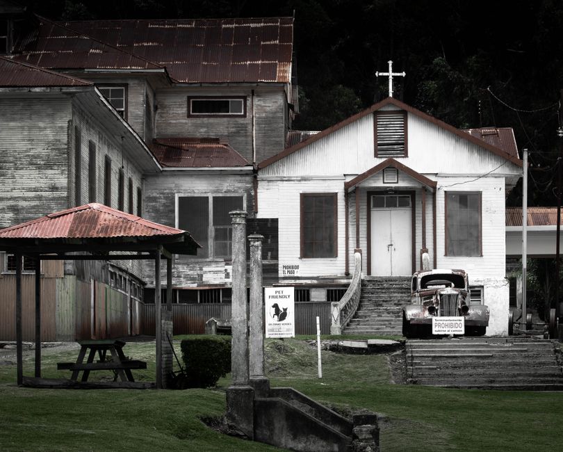 An old church with a rusty vintage truck in Cartago, Costa Rica, exuding historical charm.