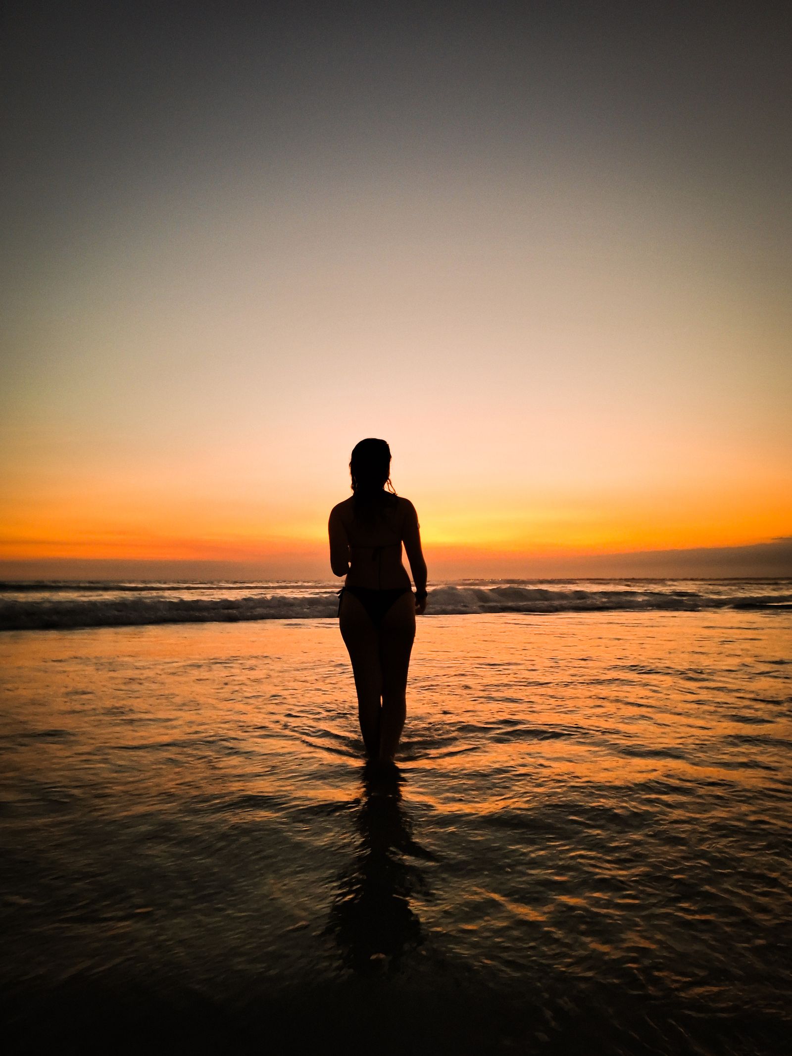Silhouette of Person Standing on Beach during Sunset · Free Stock Photo