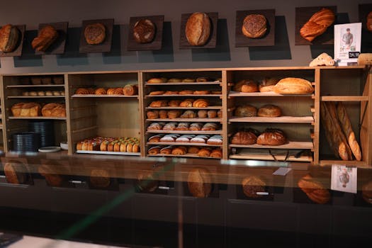 A cozy bakery showcasing an array of freshly baked bread and pastries on wooden shelves.